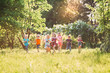 © davit85 - Large group of kids, friends boys and girls running in the park on sunny summer day in casual clothes .