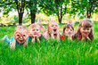 © davit85 - A group of children lying on the green grass in the Park. The interaction of the children.