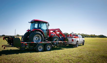 Texas Farming: Delivering/towing A Large Red Tractor.