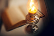 Vintage kerosene lamp and old open book