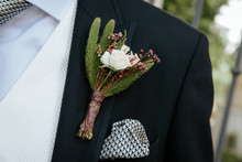 Boutonniere With A Rose On The Background Of The Groom's Jacket