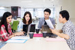© Creativa Images - Busy business team works with laptops in office