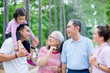 © Creativa Images - Extended family talking each other in the park