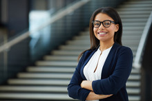 Smiling Smart Attractive Young Black Lady In Glasses Standing In Lobby And Looking At Camera, She Working In Prosperous Company