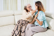 © Creativa Images - Sad woman comforted by her mother on the couch