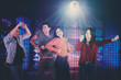 © Creativa Images - Young Asian people dancing in the nightclub