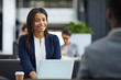 © Seventyfour - Happy confident young black woman in jacket sitting in front of laptop and talking to business partner while holding meeting in cafe