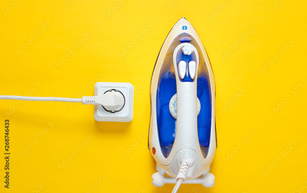 Cable Iron for ironing things plugged into a power outlet in yellow ...
