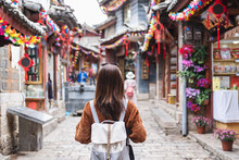 Young Woman Traveler Walking At Lijiang Old Town In China, Travel Lifestyle Concept