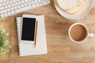 Wall Mural - top view of office table . on desk have notebook coffee cup laptop smartphone and pencil.