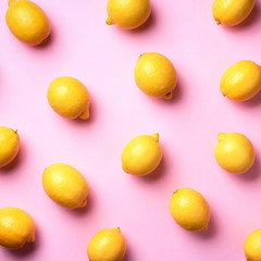 Wall Mural - food pattern with lemons on pink paper background. top view. summer concept. vegan and vegetarian di