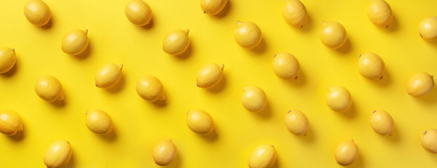 Wall Mural - food pattern with lemons on yellow paper background. top view. summer concept. vegan and vegetarian 