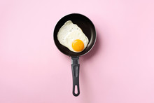 Creative Food Concept With Fried Egg On Pan Over Pink Background. Top View. Creative Pattern In Minimal Style. Flat Lay.