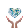 © Chinnapong - Green planet in heart shape over woman human hands isolated on white background.