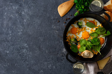 Wall Mural - Healthy breakfast eggs top view on dark stone background with copy space