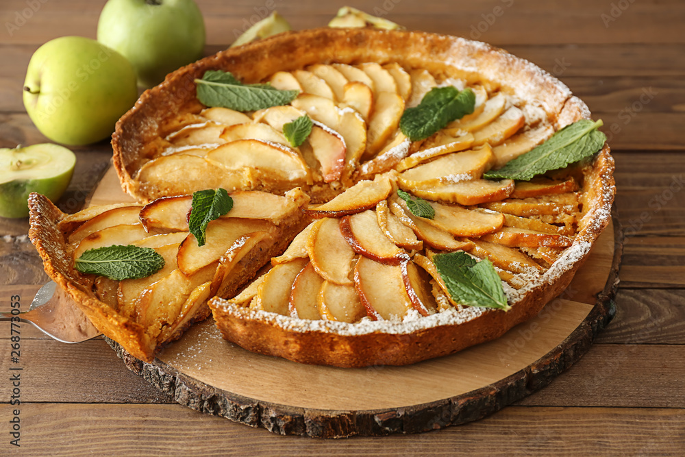 Tasty apple pie on wooden table