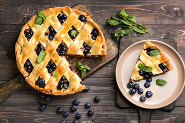 Tasty blueberry pie on wooden table