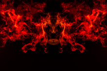 Smoke Of Different Orange And Red Colors In The Form Of Horror In The Shape Of The Head, Face And Eye With Wings On A Black Isolated Background. Soul And Ghost In Mystical Symbol