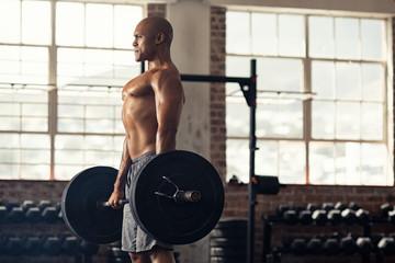 Strong black man holding weight barbell