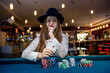 © RomanR - Poker chips and female hands holding playing cards
