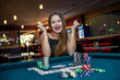 © RomanR - Happy woman in casino with poker chips and cards