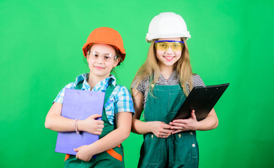 small girls repairing together in workshop. Future profession. Builder engineer architect. Kid worker in hard hat. Child care development. Tools to improve yourself. Repair. Concentrated on work