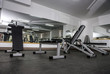 © RomanR - Modern and empty gym interior with equipment