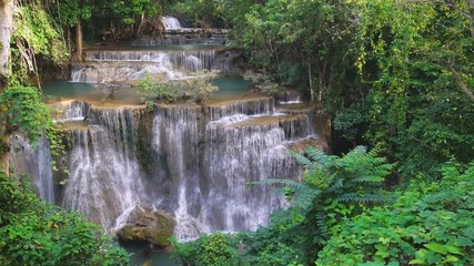 Wall Mural - Waterfall flow standing with forest enviroment high angle view in thailand called Huay or Huai mae khamin in Kanchanaburi Provience, Thailand., Panning Left, Panning.
