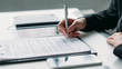 © golubovy - Modern business investment. Corporate relationship. Closeup of female hand signing contract.