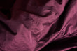 Purple fabric in the folds. drapery. Texture, background. Soft focus.