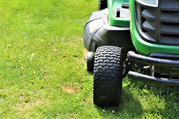 Wall Mural - lawn mower on green grass