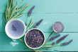 cup of lavender tea with a pile of fresh flowers, syrup, bunch, on blue wood table background