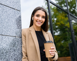 Poster - Beautiful young businesswoman wearing autumn coat