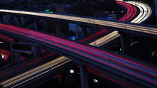 Motion Blur Of Car Light In City Highway At Dawn. Cross Intersection Of Urban Highways.