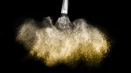 Wall Mural - golden powder splash and brush for makeup artist or beauty blogger in black background