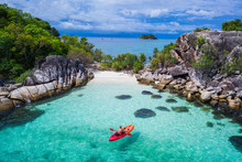 Aerial Drone View Of Man Kayaking In Crystal Clear Lagoon Sea Water During Summer Day Near Koh Kra Island In Thailand. Travel Tropical Island Holiday Concept