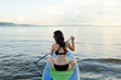 © ZHPH Production/Stocksy - Young brunette woman paddling on sup surf