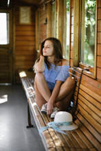 Young Woman Traveling By Old Wooden Train