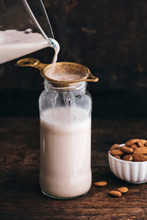 Food: Almond Milk In A Bottle With Some Almonds Besides And Blen