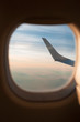 © Mika Knezevic/Stocksy - View to the sky and wing through the airplane window