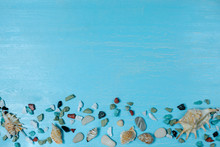 Beach Background With Big And Small Shells And Bright Color Sea Stones Flat Lay On A Light Blue  Wooden Relax Background For Summer Holiday And Vacation Concept. Travel And Tourism Idea