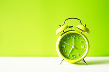 Green Alarm Clock On Green Pastel  Background With Coppy Space