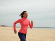 © Milles Studio/Stocksy - Content black woman jogging on shoreline