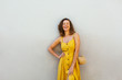 © Bonninstudio/Stocksy - Beautiful woman wearing yellow dress.