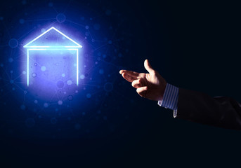 Conceptual image with hand pointing at house or main page icon on dark background