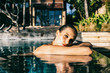 © visualspectrum/Stocksy - Pretty Caucasian Woman Relaxing in Swimming Pool