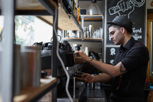 Male Waiter Preparing A Coffee With An Espresso Machine