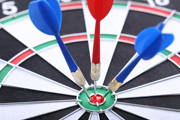 Dartboard with red and blue darts