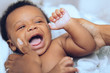 © Gerald Carter/Creative Flame - Mother's hands hold laughing baby