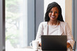 © Gerald Carter/Creative Flame - Smiling businesswoman works on laptop